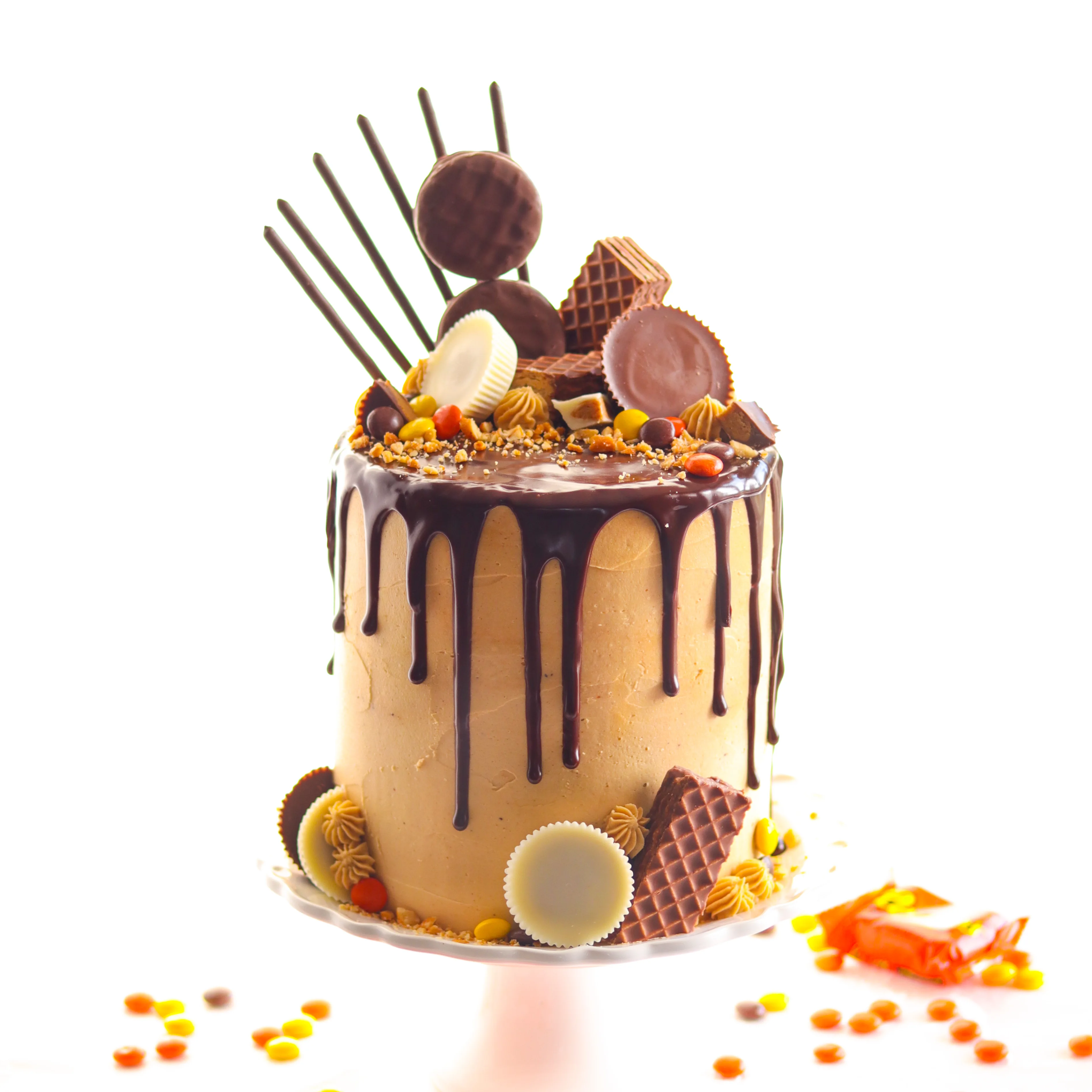 Irresistibly moist layers of deliciously dark chocolate cake frosted with creamy peanut butter frosting and enrobed in rich chocolate ganache!