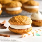 Soft and tender carrot cake cookies filled with lusciously tart and tangy cream cheese frosting!