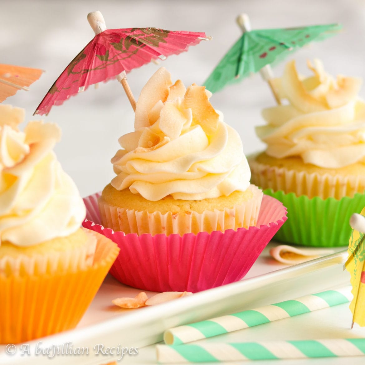 Moist and fluffy pineapple cupcakes filled with a luscious pineapple curd and finished off with a crown of coconut buttercream!