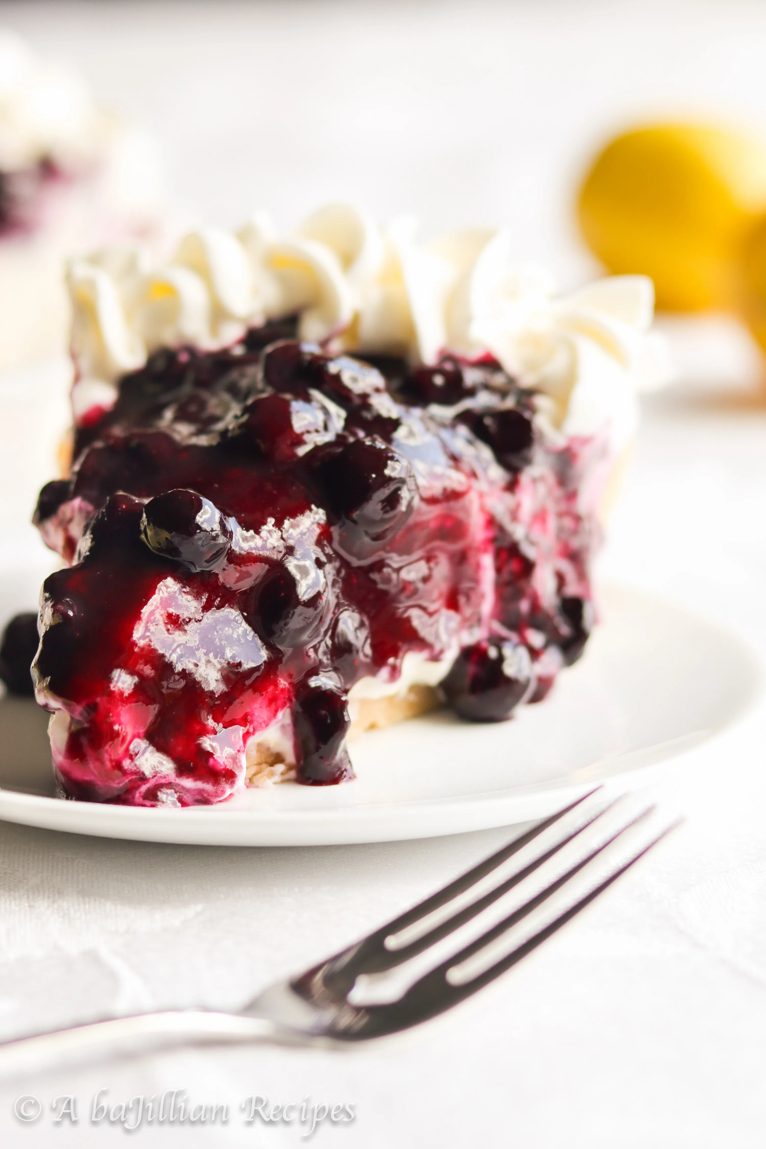 A buttery shortbread cookie crust filled with unbelievably creamy lemon mousse-like filling and topped with a sweet homemade blueberry topping!