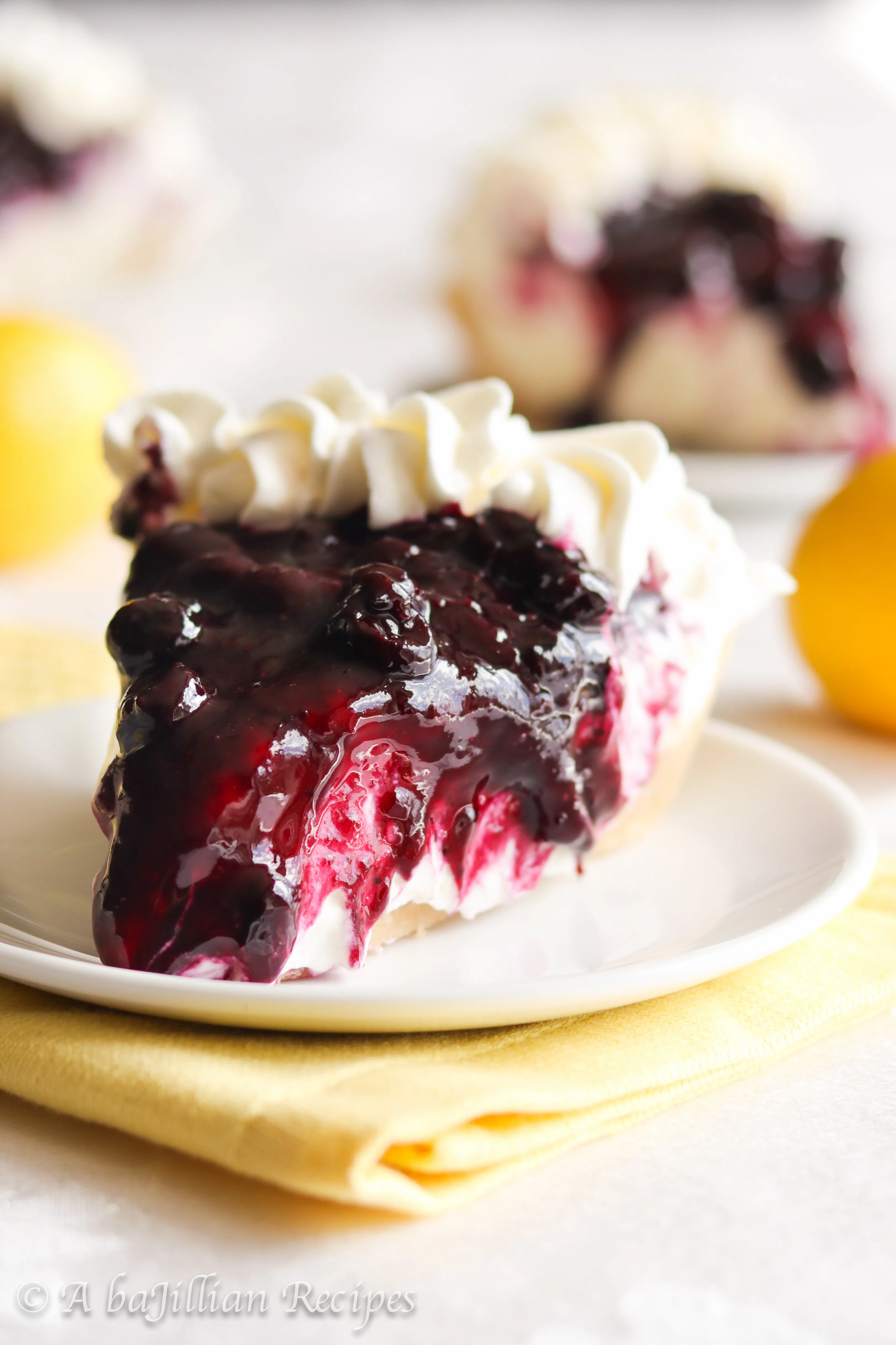 A buttery shortbread cookie crust filled with unbelievably creamy lemon mousse-like filling and topped with a sweet homemade blueberry topping!
