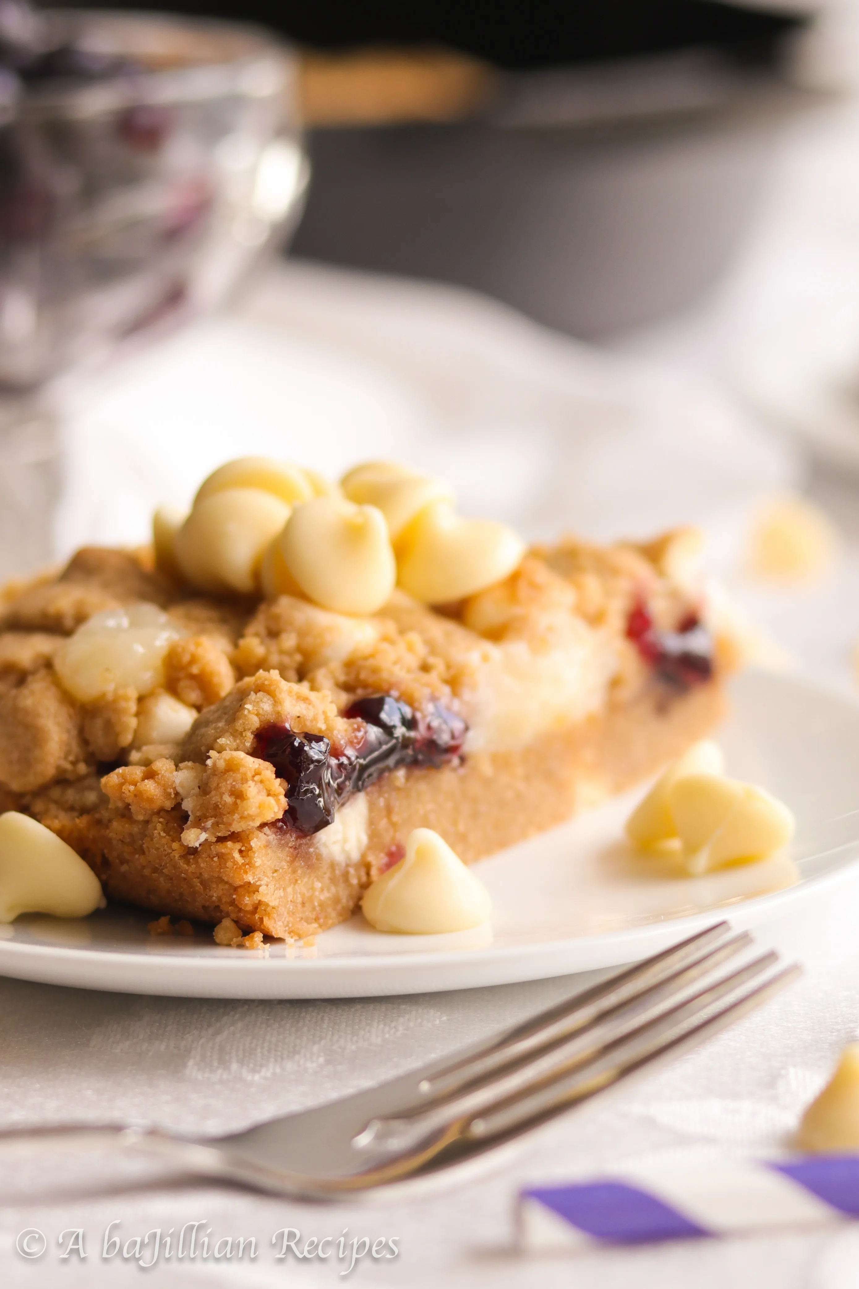 A warm, soft, and deliciously doughy graham-flavored cookie brimming with melty white chocolate chips, pockets of blueberry jam and cream cheese filling!