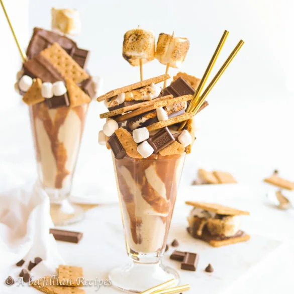 An ultra creamy toasted marshmallow milkshake drizzled with silky milk chocolate ganache and decked out in ALL of the s'more fixings!