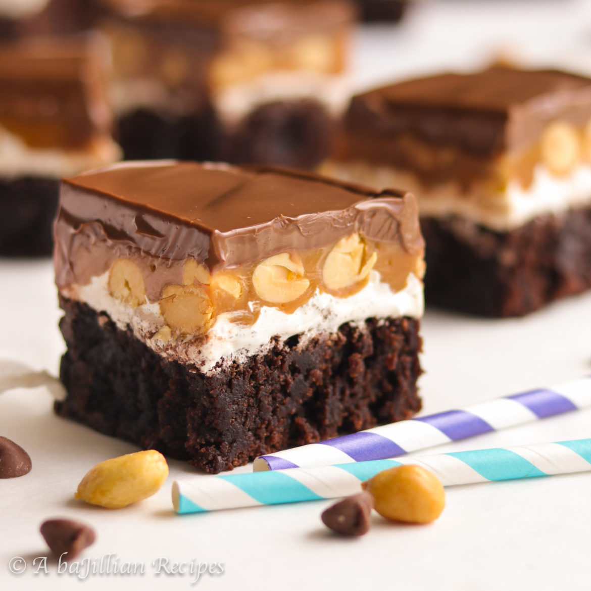 Fudgy brownies topped with layers of creamy nougat, gooey caramel, crunchy peanuts, and rich milk chocolate!