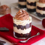 Rich and creamy layers of white chocolate cheesecake filling between fudgy brownie cubes, topped with a fluffy swirl of chocolate whipped cream and chocolate curls!