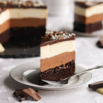 Supremely moist chocolate cake, light and creamy layers of milk AND white chocolate mousse, and a velvety blanket of rich chocolate ganache!