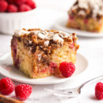 A moist and fluffy vanilla cake swirled with brown sugary cinnamon swirls, loaded with juicy raspberries, topped with a buttery streusel topping, and drizzled in a luscious vanilla icing!