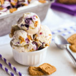 Cool and creamy cheesecake ice cream swirled with fresh blueberry sauce and brimming with buttery bits of Biscoff cookies!