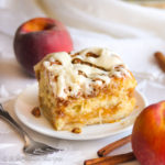 Ultra fluffy and pillowy cinnamon rolls loaded with both buttery brown sugar cinnamon filling and fresh peach filling, topped with a brown sugary crumble and drizzled in cream cheese icing!