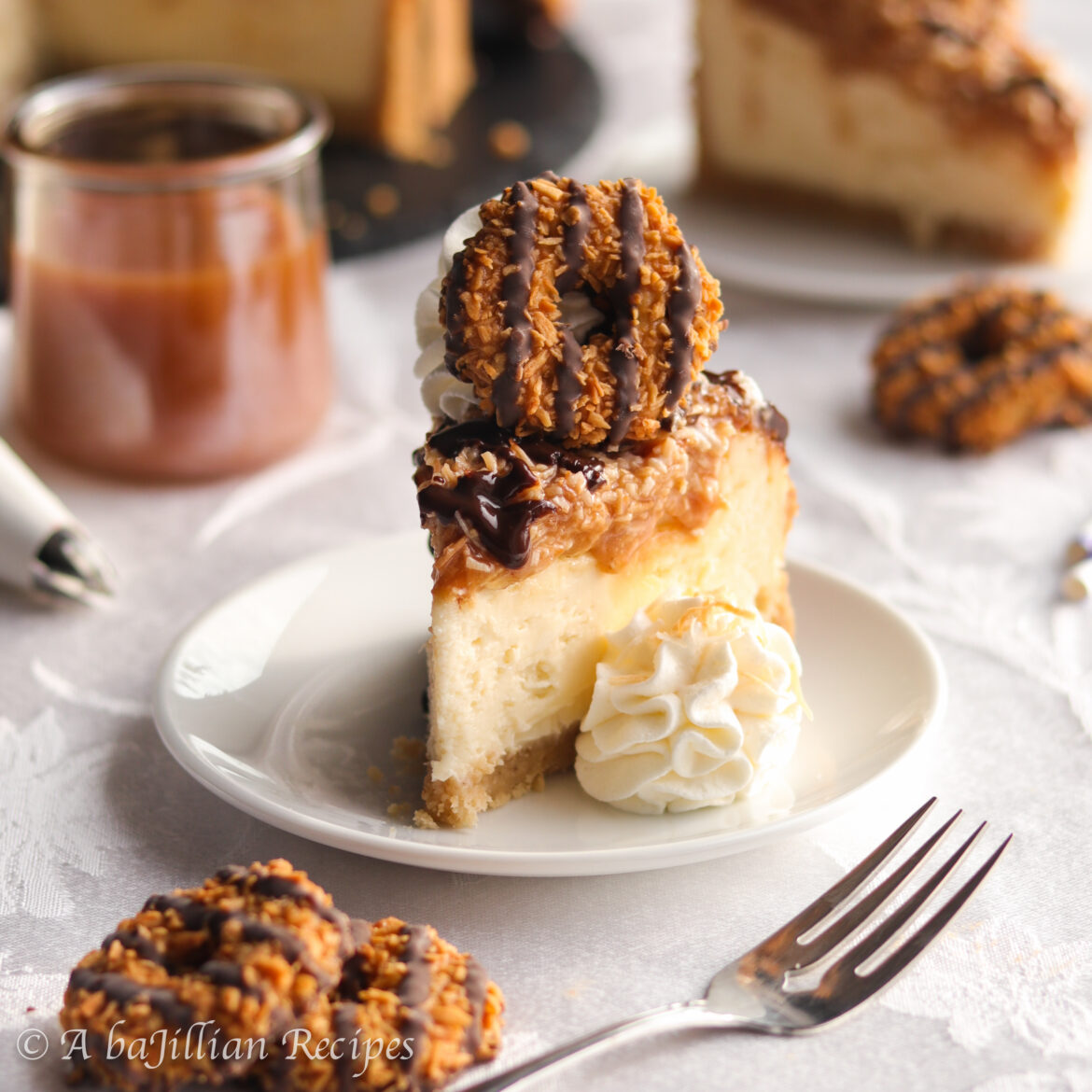 This Samoa Cheesecake is rich, dense, and indulgently creamy! It’s baked in a crisp shortbread cookie crust, topped with caramel coconut topping, drizzled in chocolate ganache, and crowned with everyone's favorite Samoa cookies!