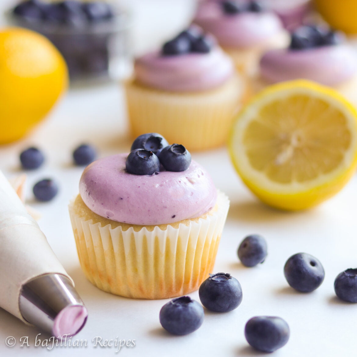 Supremely moist lemon cupcakes filled with homemade blueberry curd and crowned with blueberry cream cheese frosting!