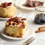 Exceptionally soft and fluffy cinnamon rolls swirled with buttery brown sugar filling and candied bacon, slathered in maple cream cheese frosting, and sprinkled with MORE candied bacon!