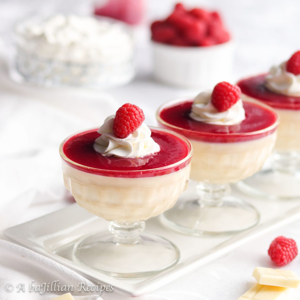 Exquisitely smooth and sensuous, this White Chocolate Raspberry Pot de Crème is deliciously decadent and topped with a lusciously sweet, yet tart raspberry sauce!