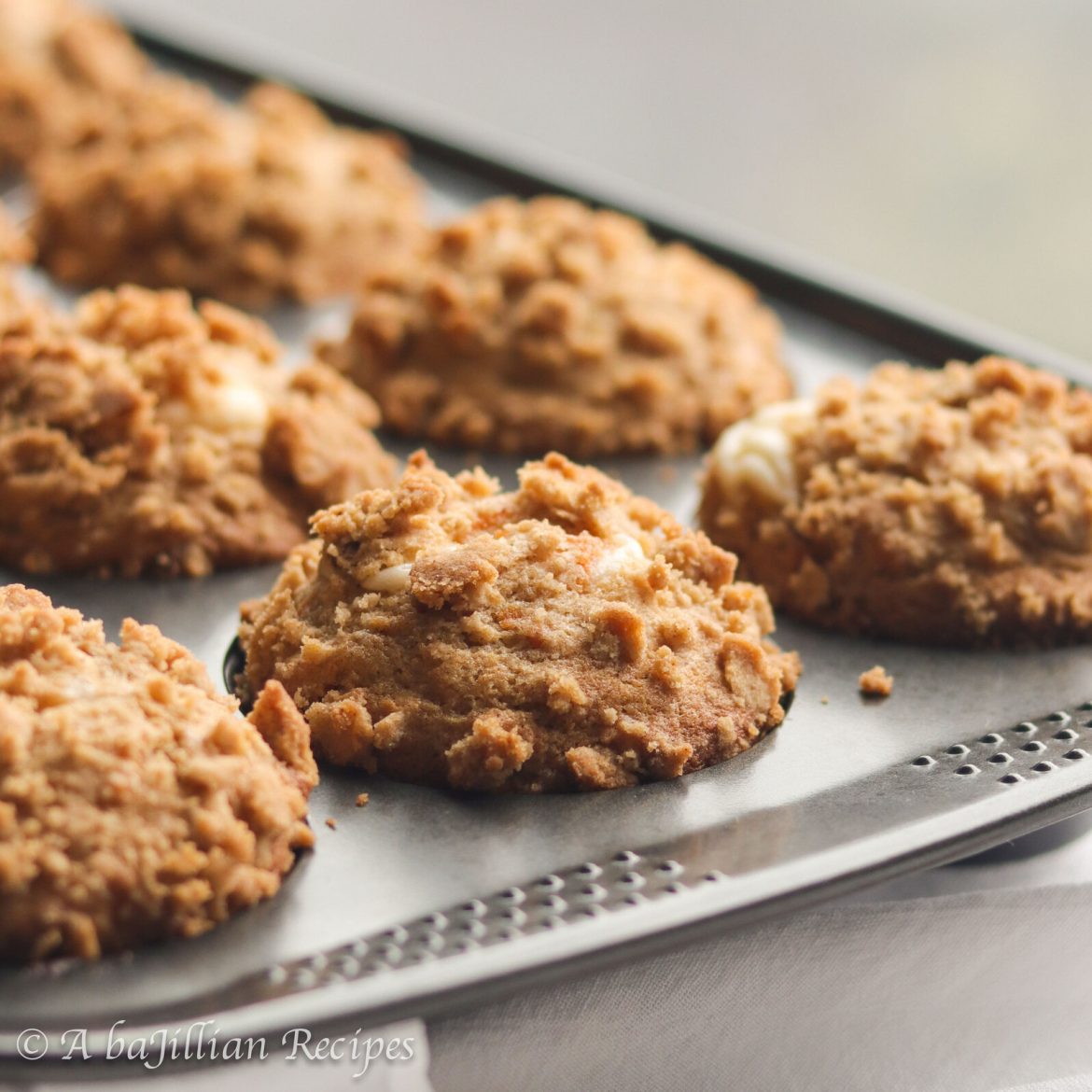 Moist and fluffy carrot cake muffins stuffed with a sweetened cream cheese filling and topped with a golden toasty streusel!