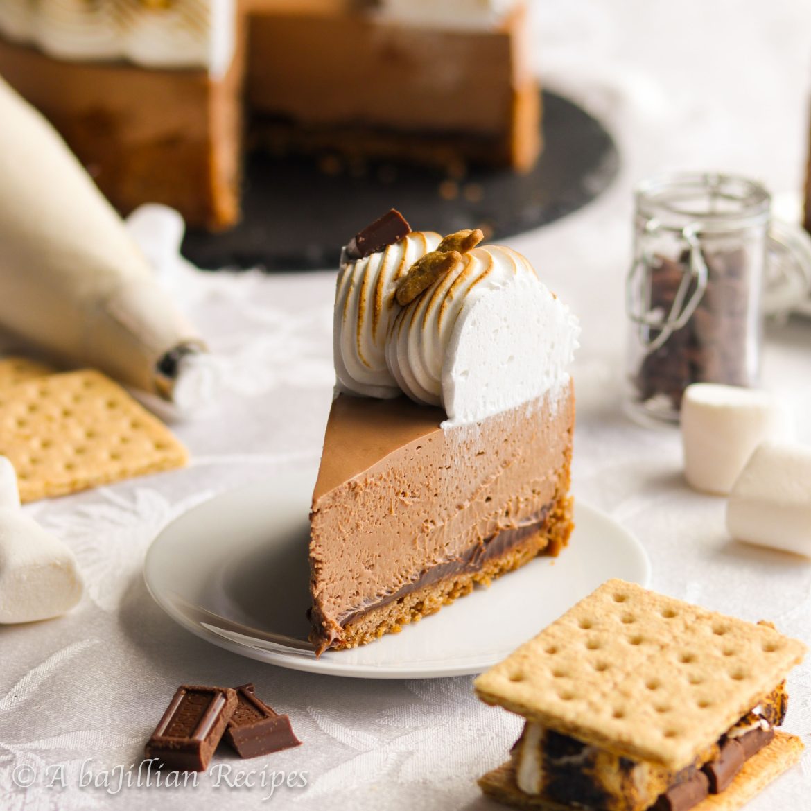 Rich and creamy chocolate cheesecake nestled in a crisp graham cracker crust and finished with a fluffy crown of toasted Swiss meringue!