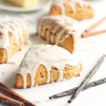 Super soft, tall, and tender, these scones are flavored with the fall sweetness of pumpkin and generously drizzled in a blissful vanilla bean icing!