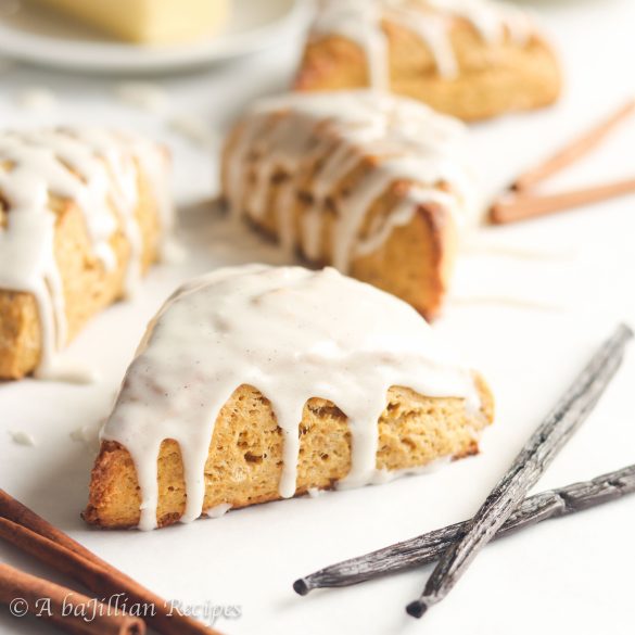 Super soft, tall, and tender, these scones are flavored with the fall sweetness of pumpkin and generously drizzled in a blissful vanilla bean icing!