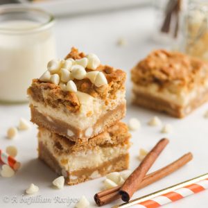 Soft and chewy pumpkin white chocolate chip cookie dough and creamy vanilla cheesecake baked together in one deliciously decadent bar!