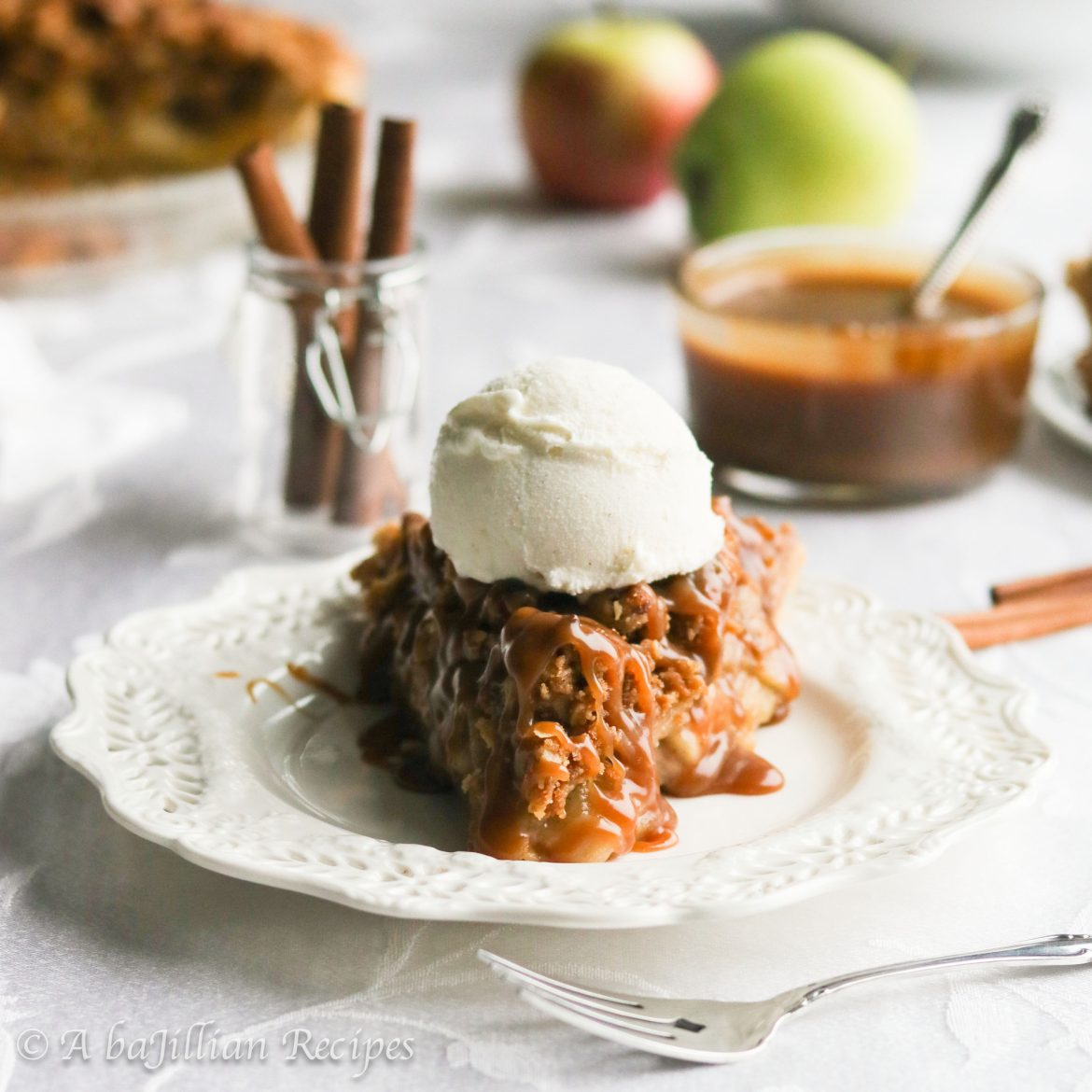 Tender apples baked in rich homemade toffee sauce, surrounded by a golden flaky crust, and crowned with a mountain of Biscoff streusel topping!