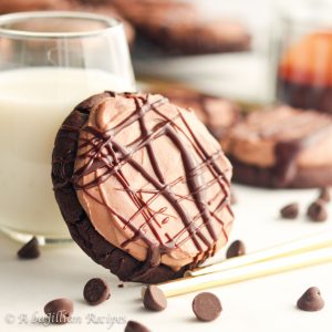 Soft and chewy chocolate cookies topped with a creamy chocolate cheesecake mousse and finished with a silky smooth drizzle of chocolate ganache!