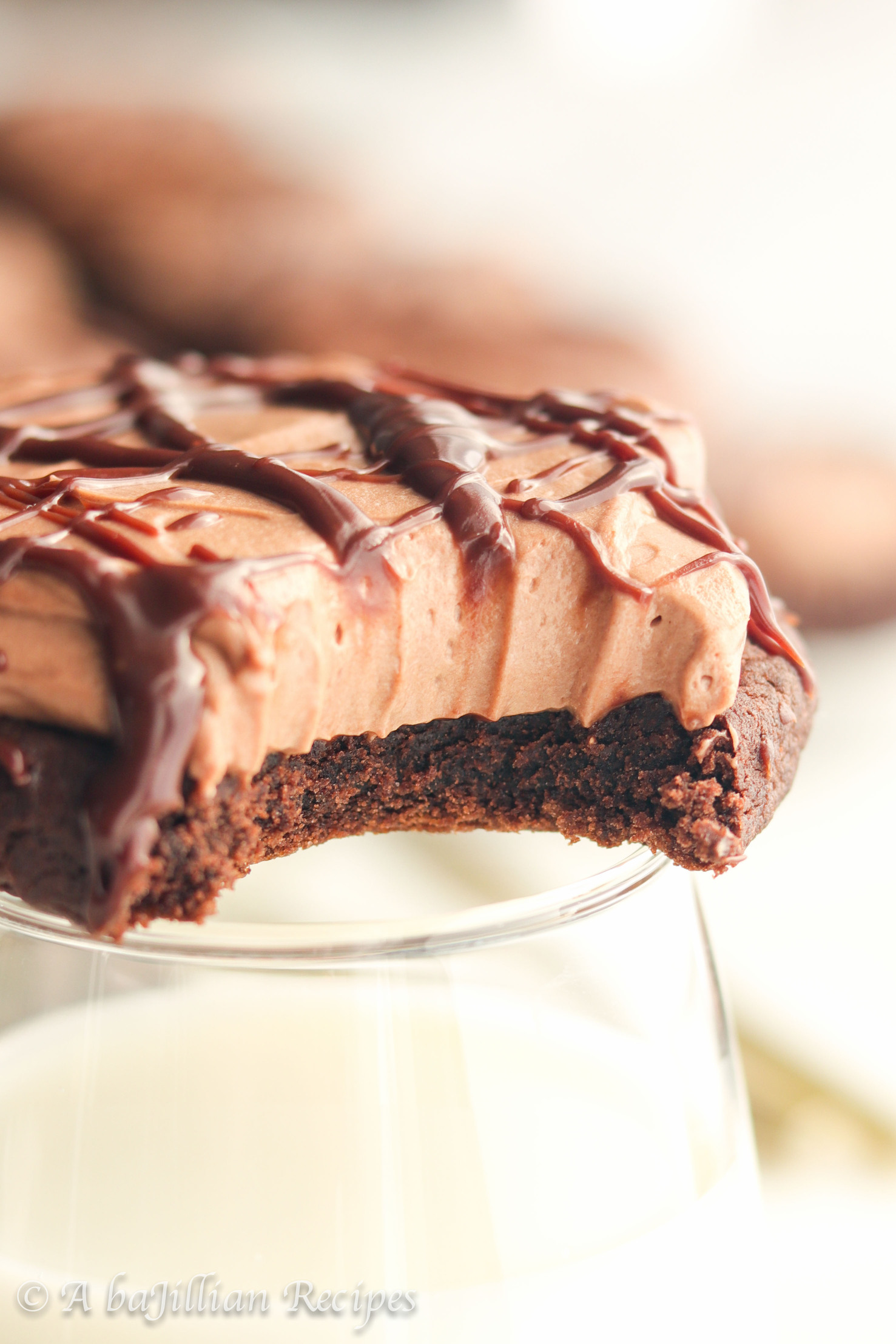 Soft and chewy chocolate cookies topped with a creamy chocolate cheesecake mousse and finished with a silky smooth drizzle of chocolate ganache!