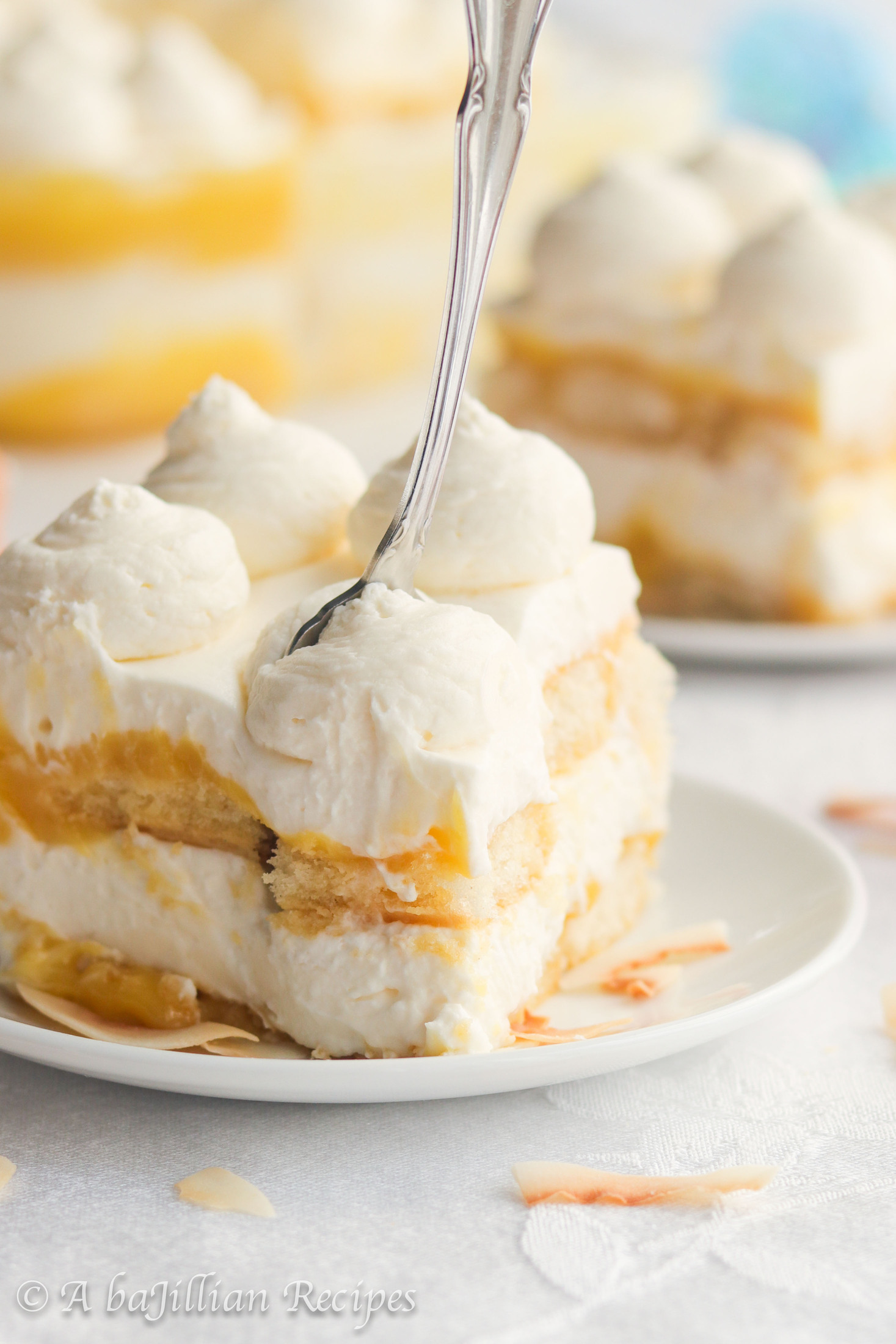 This Piña Colada Tiramisu contains layers of pineapple syrup-soaked ladyfingers, lusciously tangy pineapple curd, and fluffy coconut-kissed mascarpone filling!