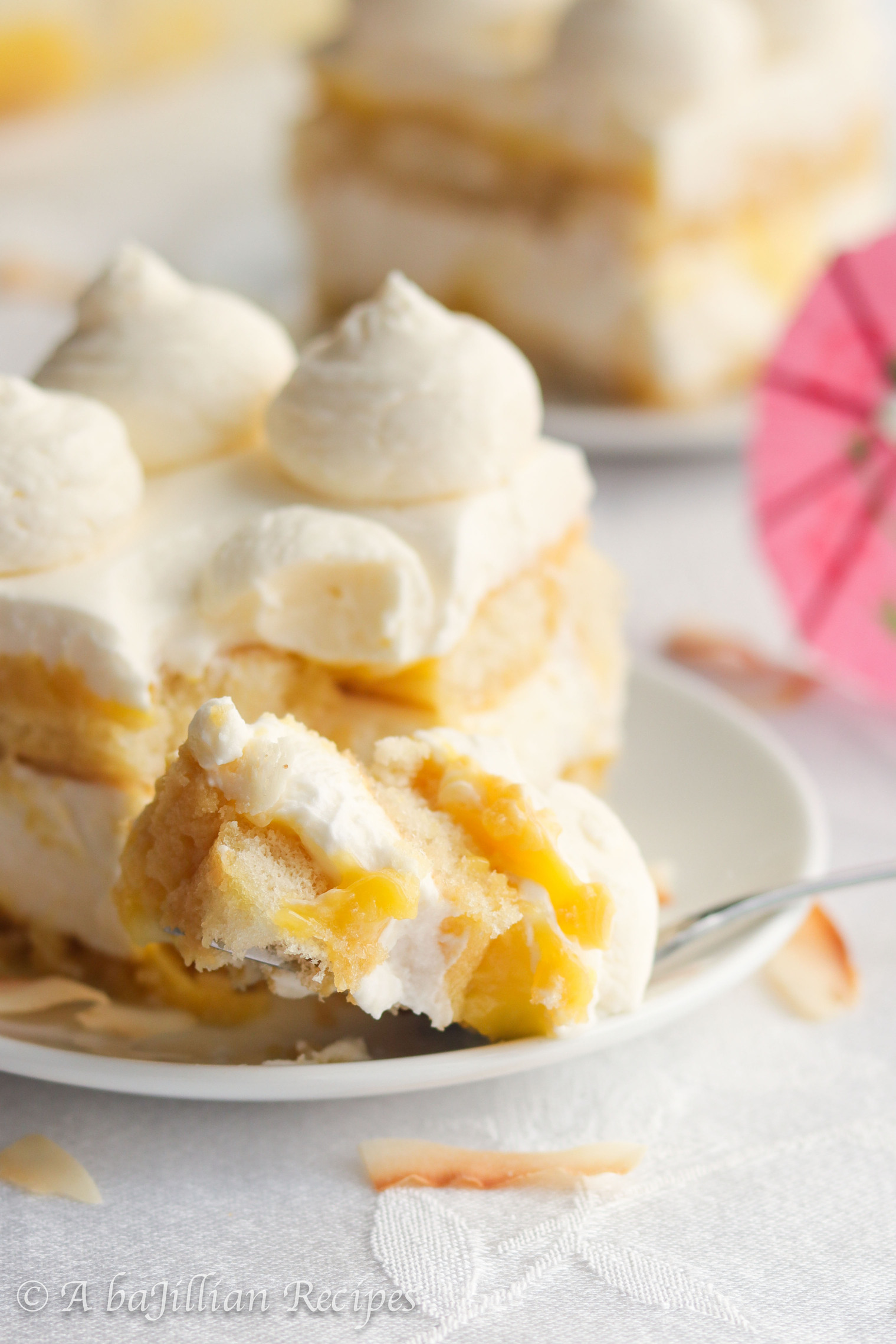 This Piña Colada Tiramisu contains layers of pineapple syrup-soaked ladyfingers, lusciously tangy pineapple curd, and fluffy coconut-kissed mascarpone filling!