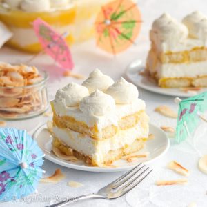 This Piña Colada Tiramisu contains layers of pineapple syrup-soaked ladyfingers, lusciously tangy pineapple curd, and fluffy coconut-kissed mascarpone filling!