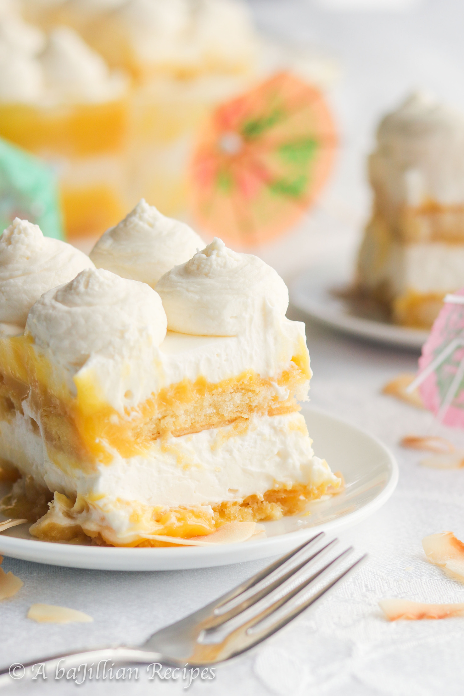 This Piña Colada Tiramisu contains layers of pineapple syrup-soaked ladyfingers, lusciously tangy pineapple curd, and fluffy coconut-kissed mascarpone filling!