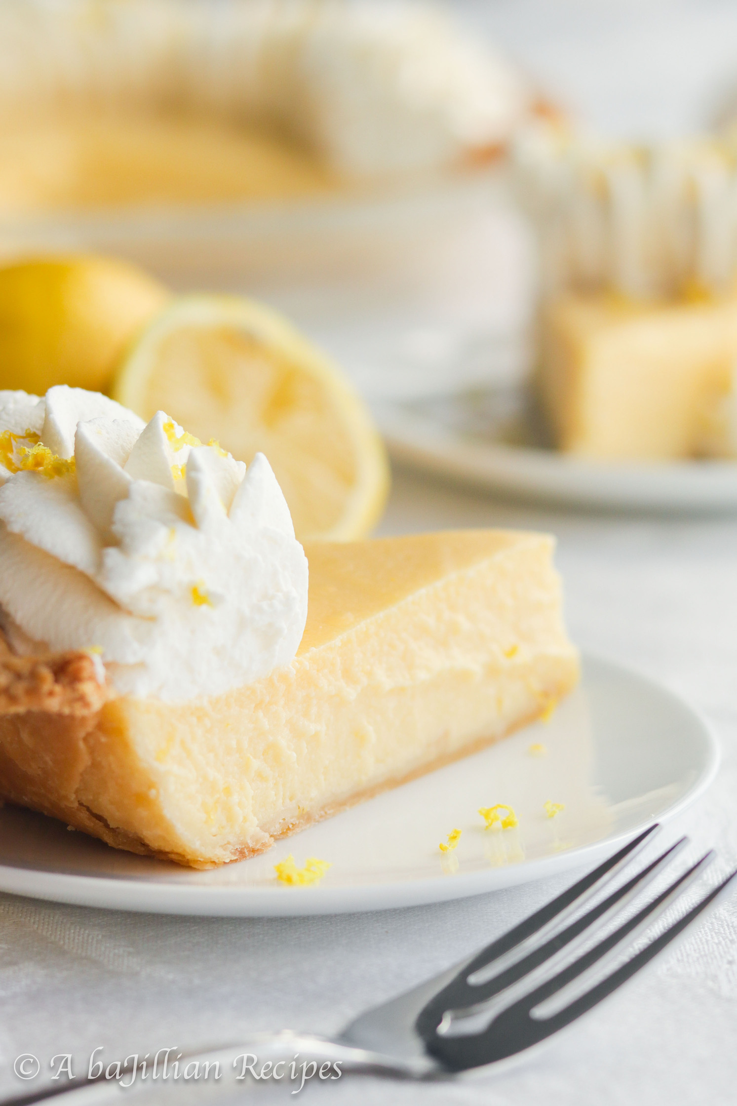 Smooth and creamy lemon filling nestled in a golden flaky pastry crust and crowned with a fluffy border of lemon-kissed whipped cream.