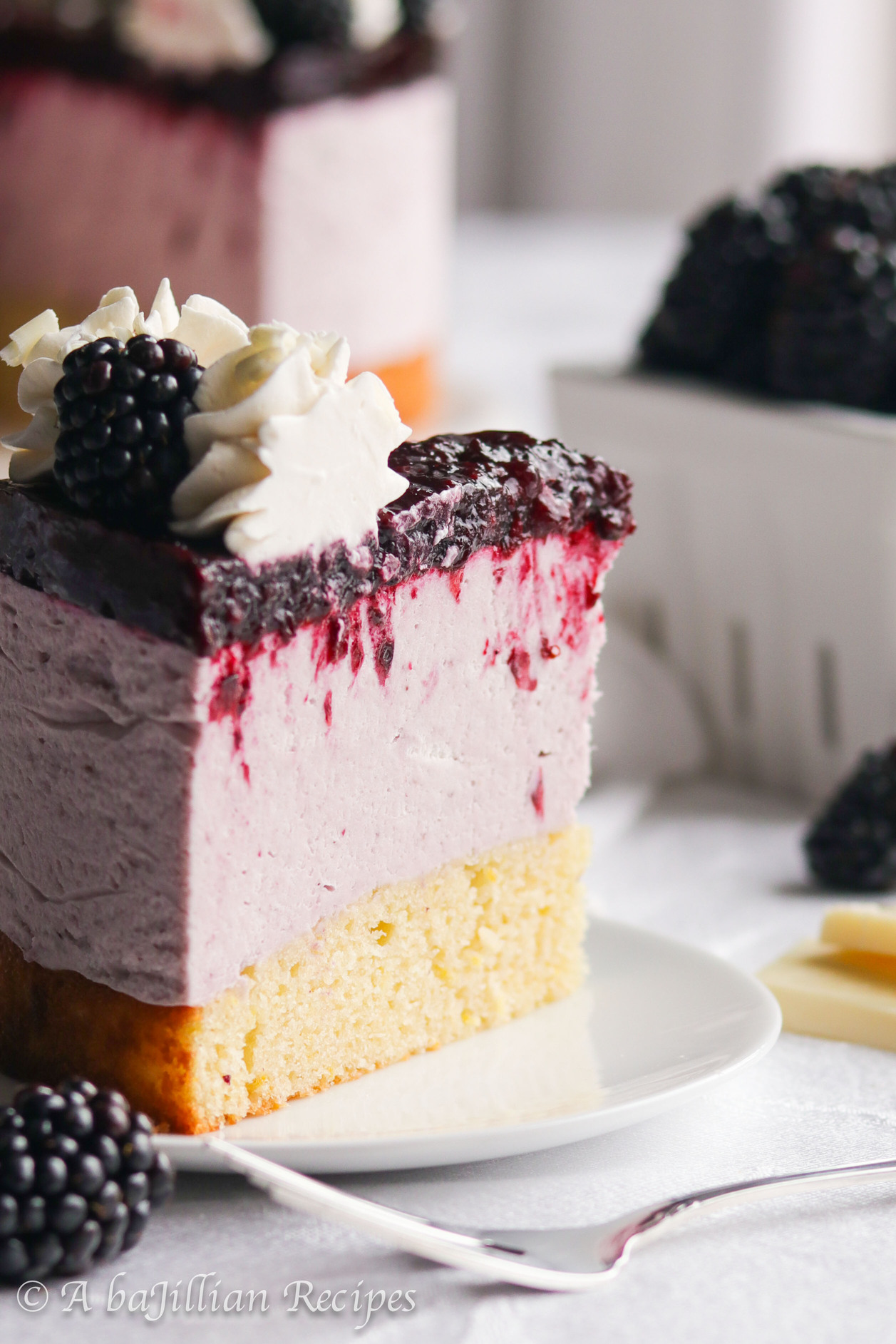 Both elegant and heavenly, this Blackberry White Chocolate Mousse Cake features moist and tender vanilla cake, blackberry white chocolate mousse, and luscious blackberry topping!