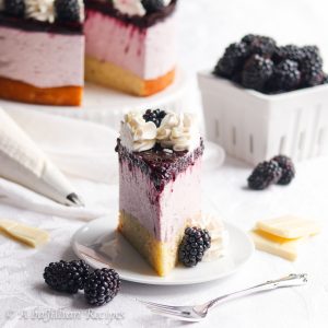 Both elegant and heavenly, this Blackberry White Chocolate Mousse Cake features moist and tender vanilla cake, blackberry white chocolate mousse, and luscious blackberry topping!