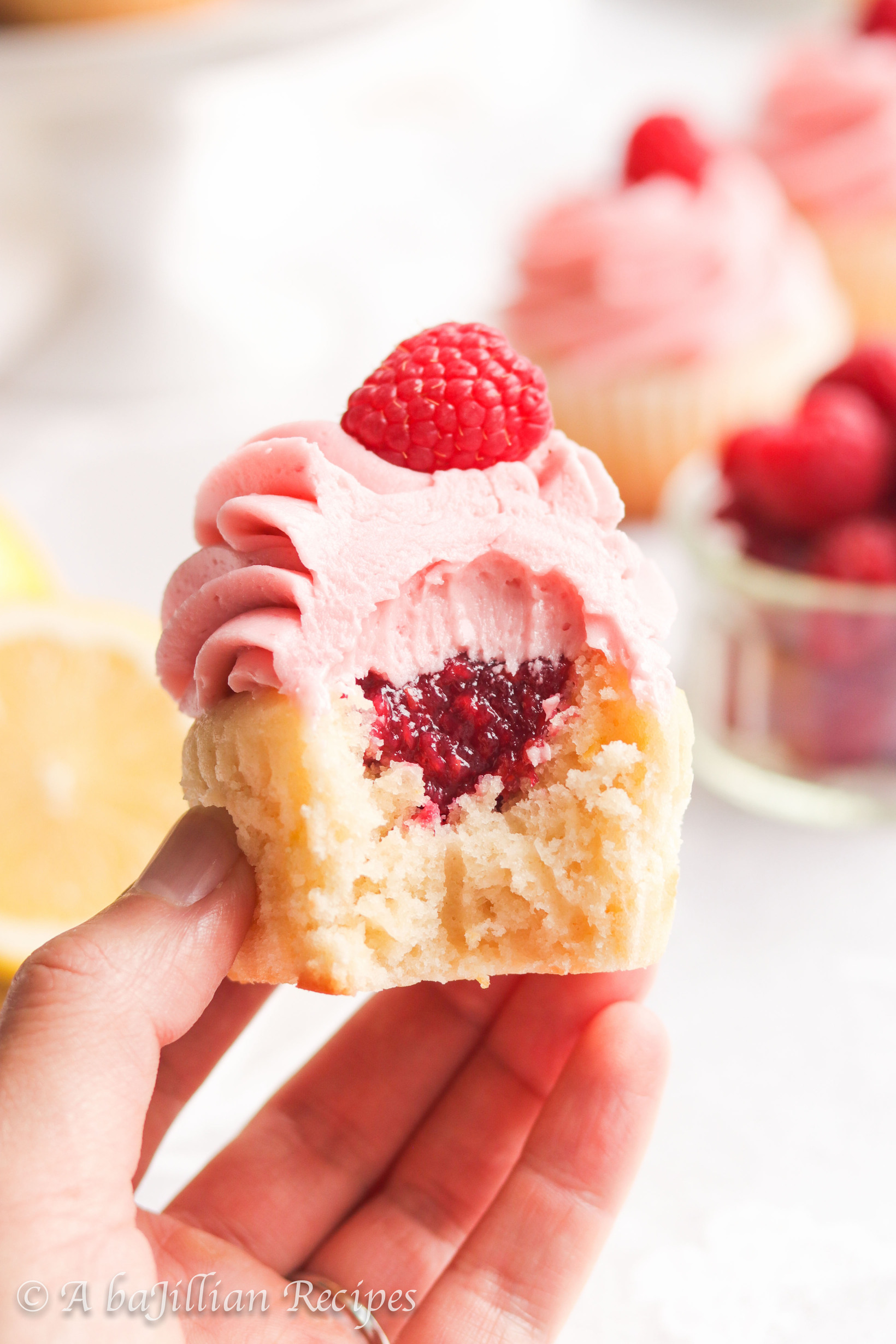 Moist and fluffy lemon cupcakes filled with fresh raspberry filling and crowned with creamy raspberry buttercream frosting!