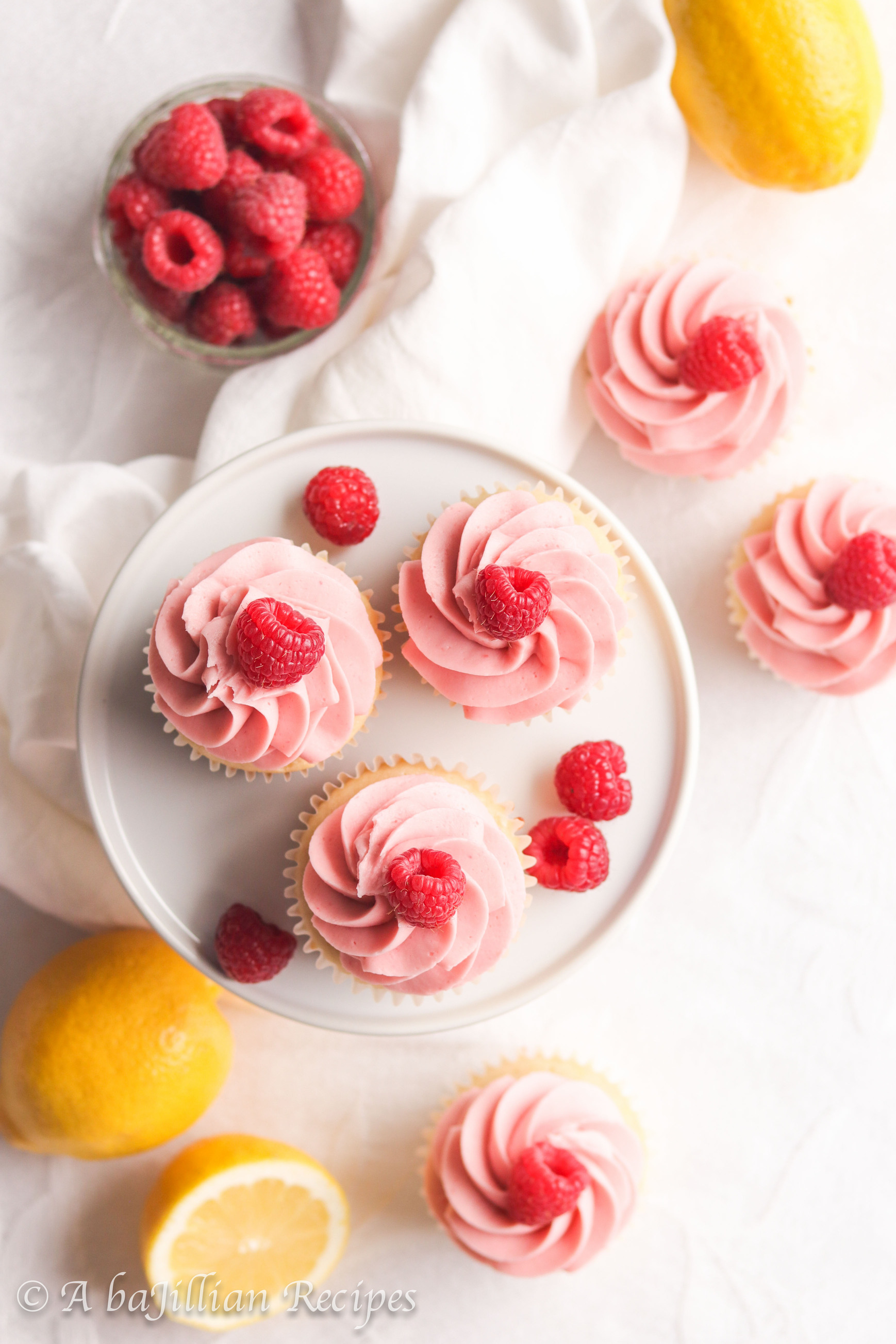 Moist and fluffy lemon cupcakes filled with fresh raspberry filling and crowned with creamy raspberry buttercream frosting!