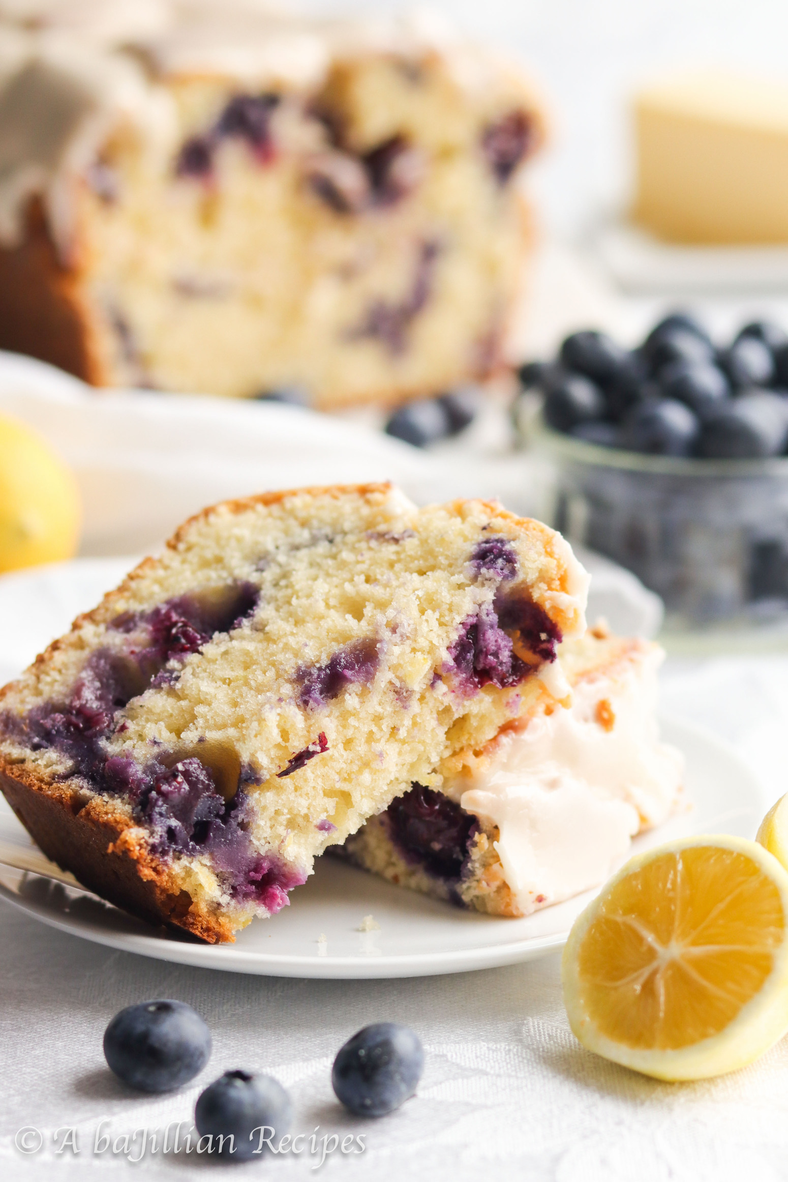 This Lemon Blueberry Bread bakes up soft, tender, and exquisitely moist. It's brimming with juicy blueberries and finished with silky smooth lemon icing!
