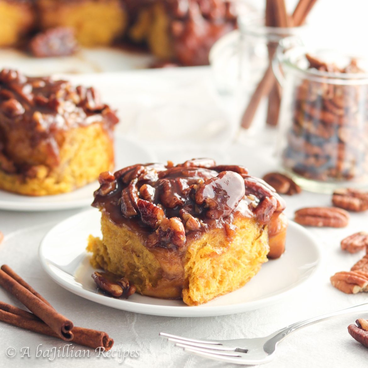 Baked in a luscious toffee bath that's loaded with toasted pecans, these sticky buns are incredibly soft, fluffy, and infused with the autumn sweetness of pumpkin!